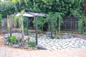 water-wise-small-backyard-with-flagstone-patio-pergola-and-drought-tolerant-plants-small-california-backyard-with-big-dogs.jpg